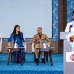 Conference Panel with Floral Backdrop