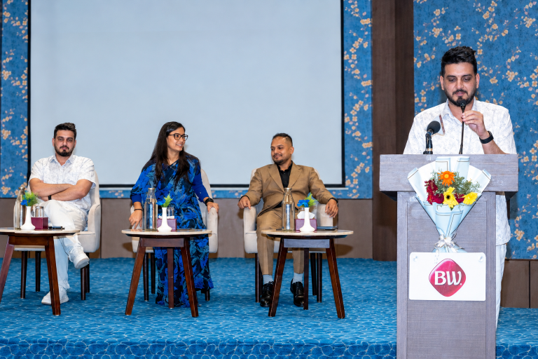 Conference Panel with Floral Backdrop